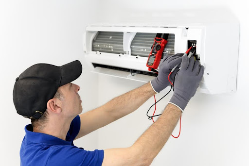 A repairman checks the multimeter measurement