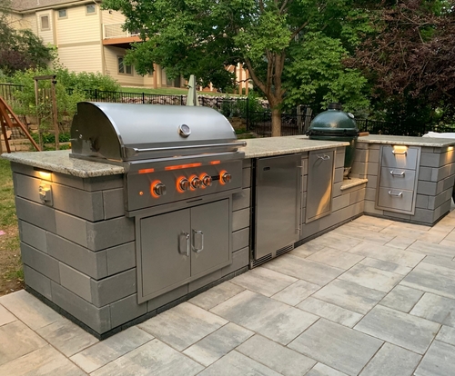 An outdoor kitchen setup with a built-in grill.