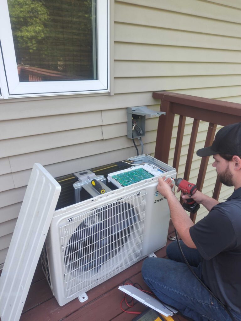 A Schroeder's technician repairs a AC unit